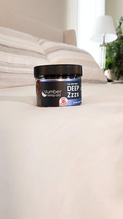 product shot highlighting deep zzzs sleep gummies on a neutral colored bedroom