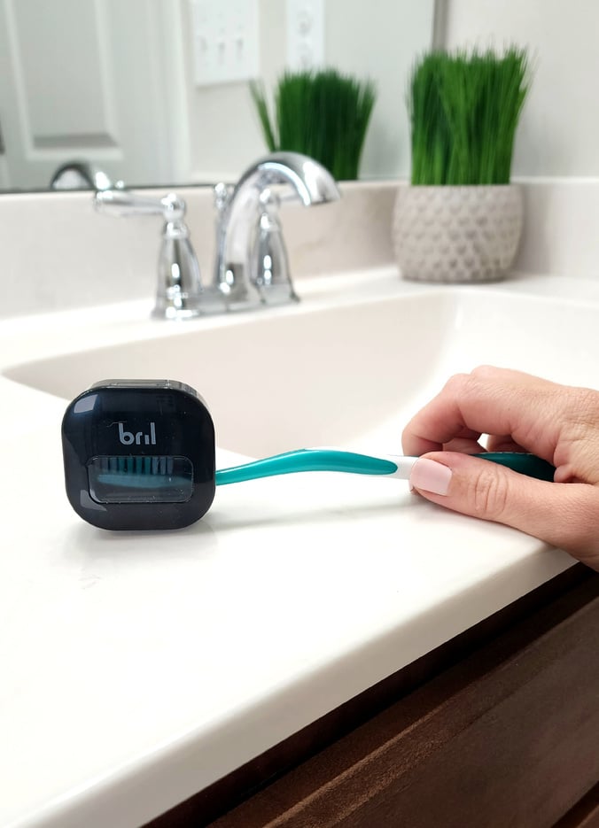 health and wellness ugc creator using a UV toothbrush cleaning product
